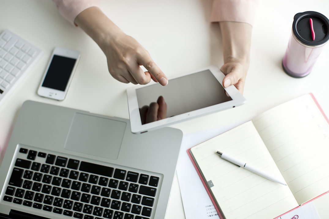 Office desk with tablet and notebook